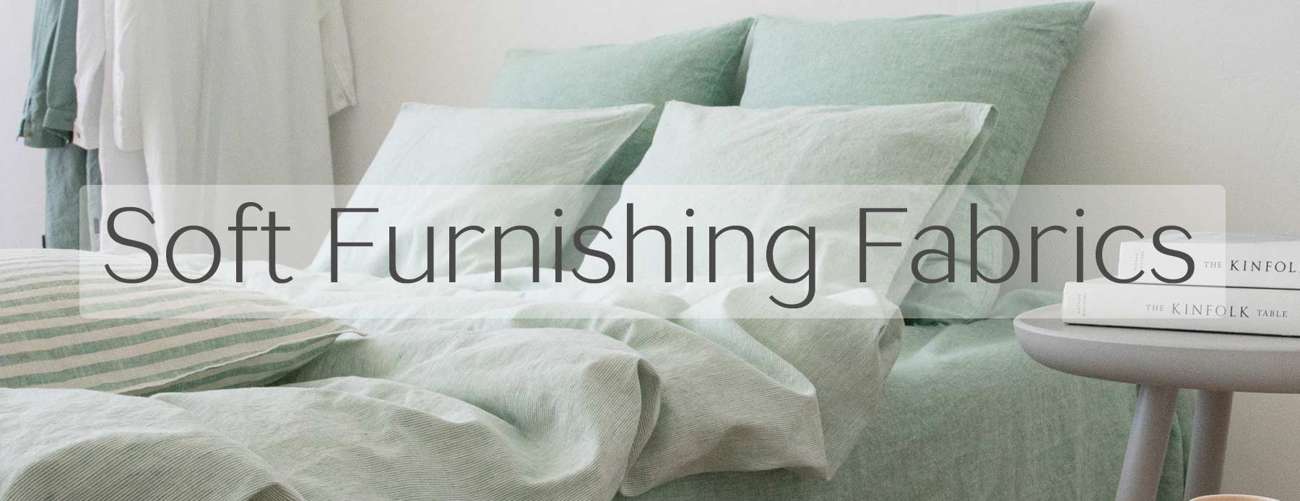 Soft furnishing linen fabrics on pale green bedding