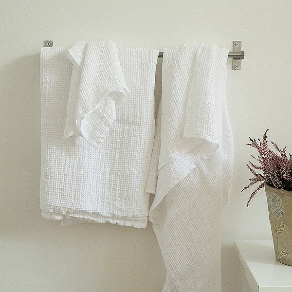 Natural linen towels for a home spa Soft natural linen towels arranged in a home-spa bathroom