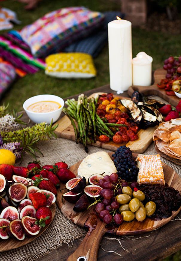 Relaxed outdoor picnic setting with low seating and neutral textiles
