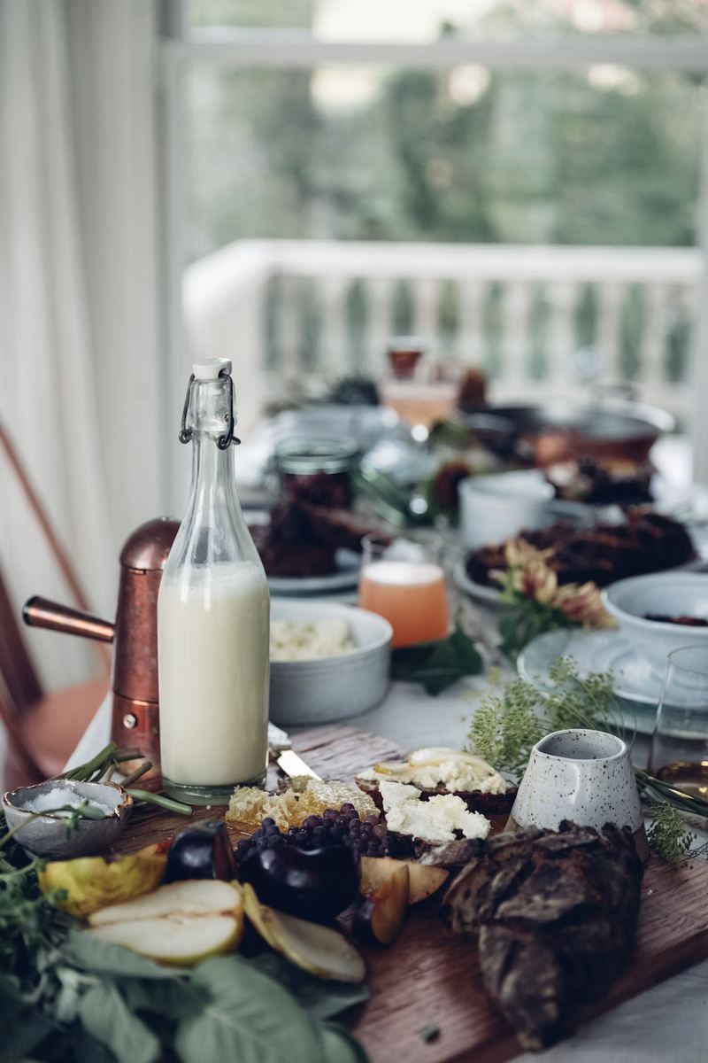 Glass bottle filled with milk on a breakfast table