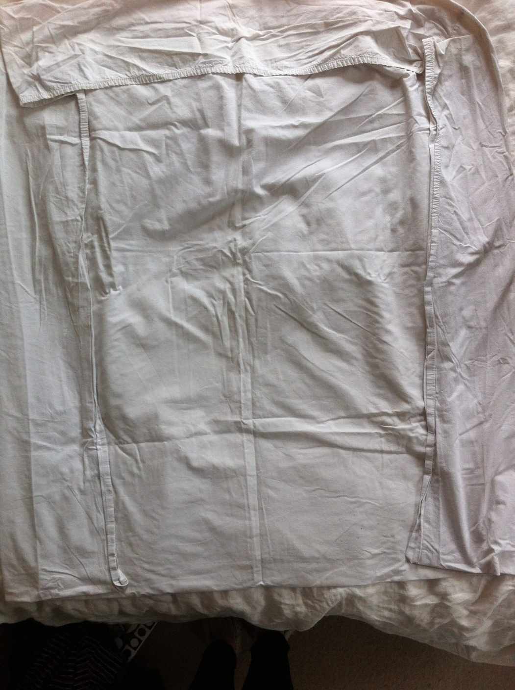 Step 3: add the third corner Third fitted-sheet corner being added to the stack