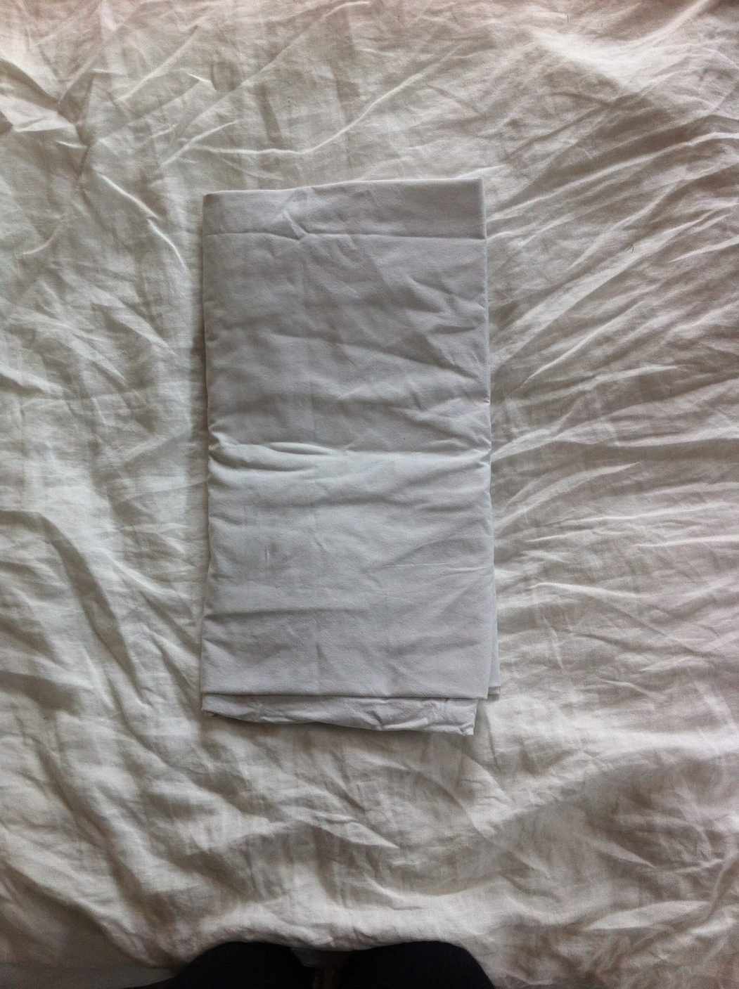 Step 6: finish folding the fitted sheet Fitted sheet folded into a neat rectangular bundle