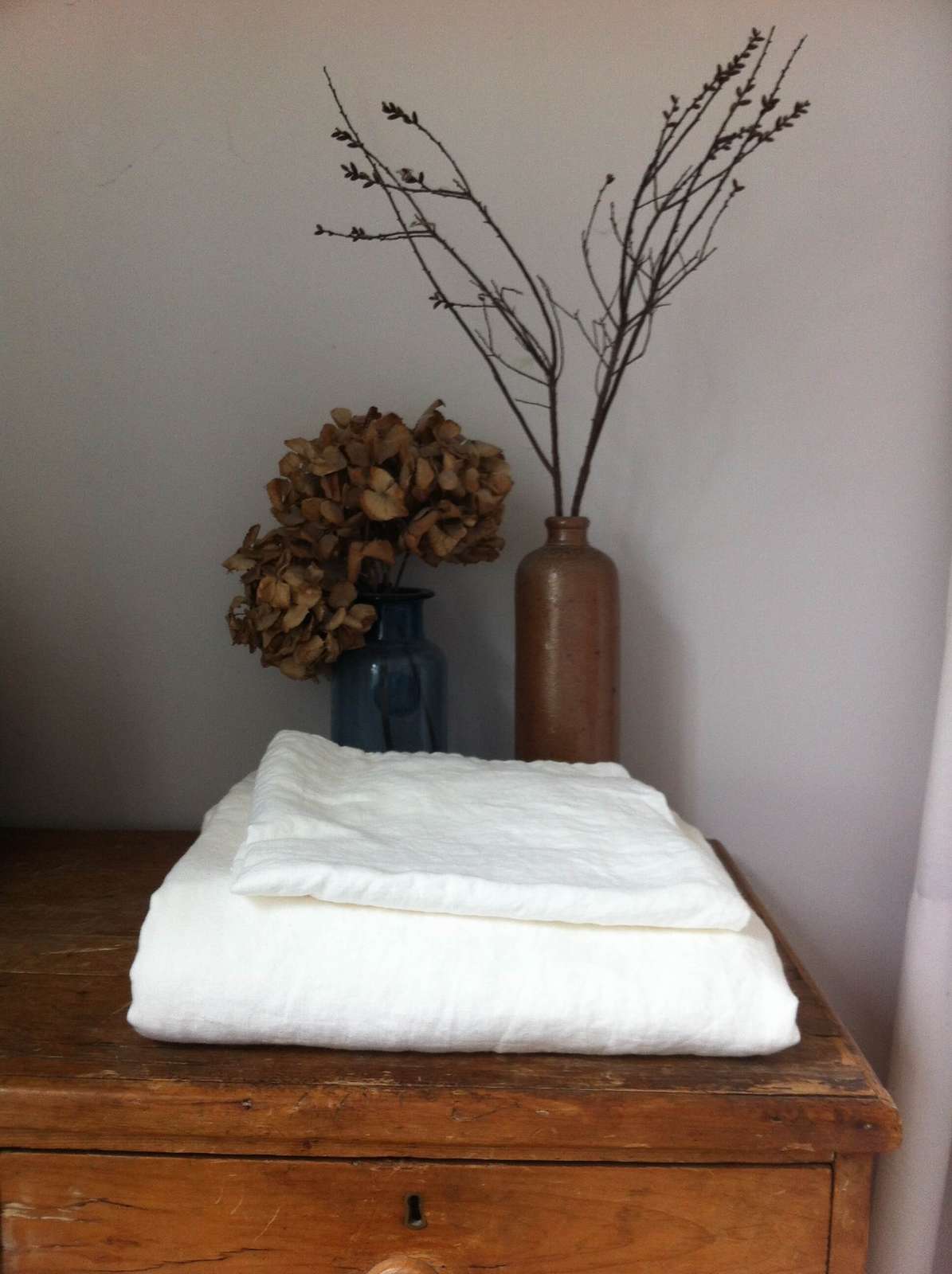 Organised fitted-sheet storage Neatly folded fitted sheets organised for storage
