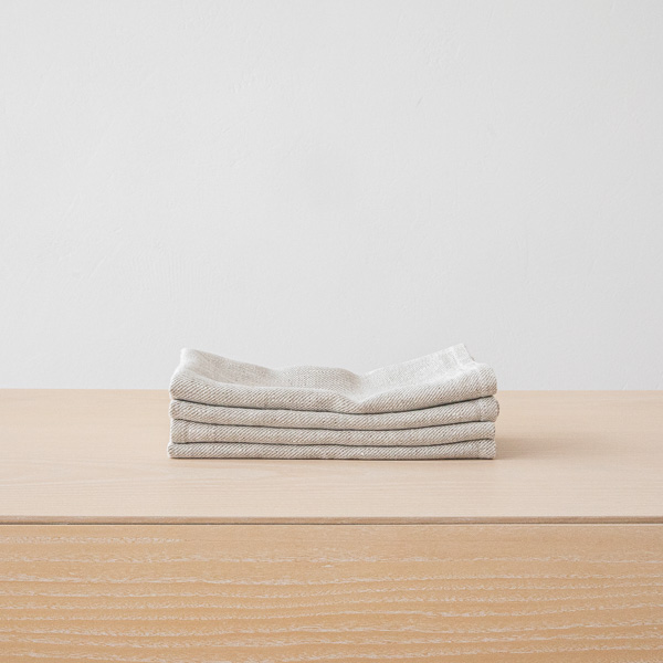 Stack of grey linen napkins for a monochrome table setting