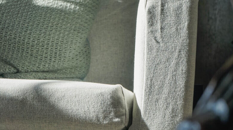 Close view of a textured neutral sofa upholstery fabric