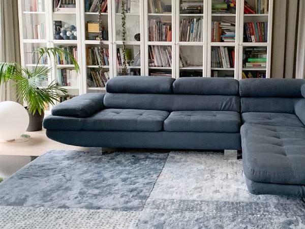 Blue linen upholstered sofa in a bright living room