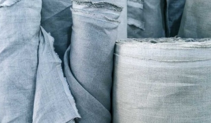 Linen fabric samples, measuring tape and project notes arranged for online selection