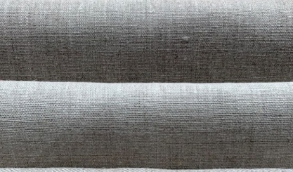 Linen upholstery fabric on a sofa being cleaned gently