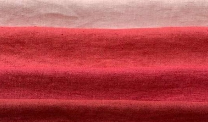 Layered linen fabrics in red, turquoise, grey and natural colours
