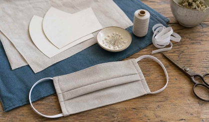 Linen face covering sewing project with fabric, pattern, elastic and thread
