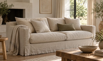 Natural linen slipcover fitted over a sofa in a light-filled living room