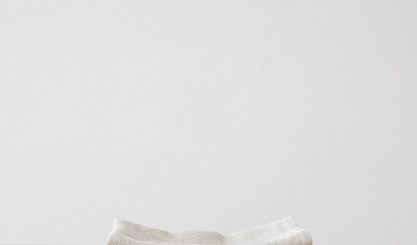 Stack of grey linen napkins for a monochrome table setting