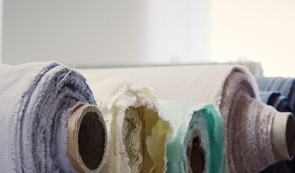 Natural linen fabric, thread and sewing tools prepared for a project