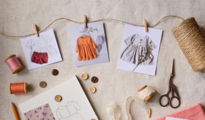 Linen craft workspace with offcuts, thread, scissors and a stitched sachet