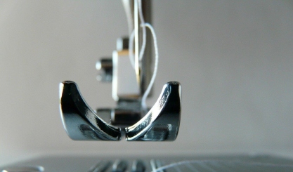 Sewing machine needle being changed before sewing fabric