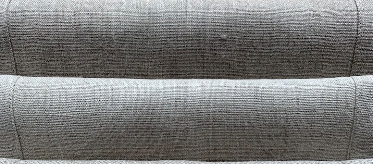 Linen upholstery fabric on a sofa being cleaned gently