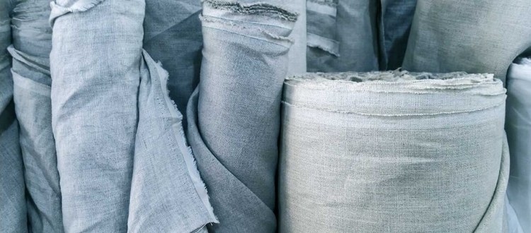 Linen fabric samples, measuring tape and project notes arranged for online selection