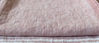 Linen fabric being gently stretched by hand