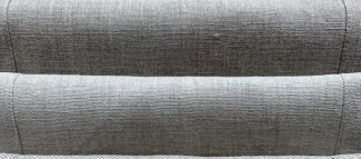 Linen upholstery fabric on a sofa being cleaned gently