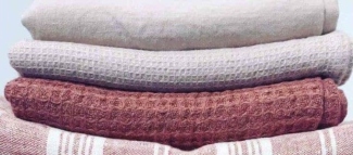 Neatly folded linen textiles stored in a breathable stack
