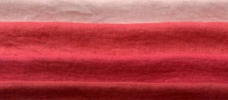 Layered linen fabrics in red, turquoise, grey and natural colours