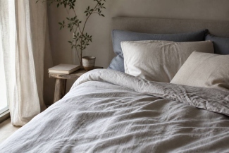 Restful bedroom with layered natural linen duvet cover and pillows