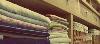 Neatly folded fitted sheet prepared for organised linen storage