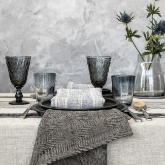 Linen tablecloth and napkins arranged on a welcoming dining table