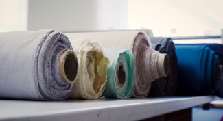 Fabric seam puckering beside a sewing machine stitch line