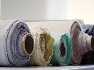 Natural linen fabric, thread and sewing tools prepared for a project